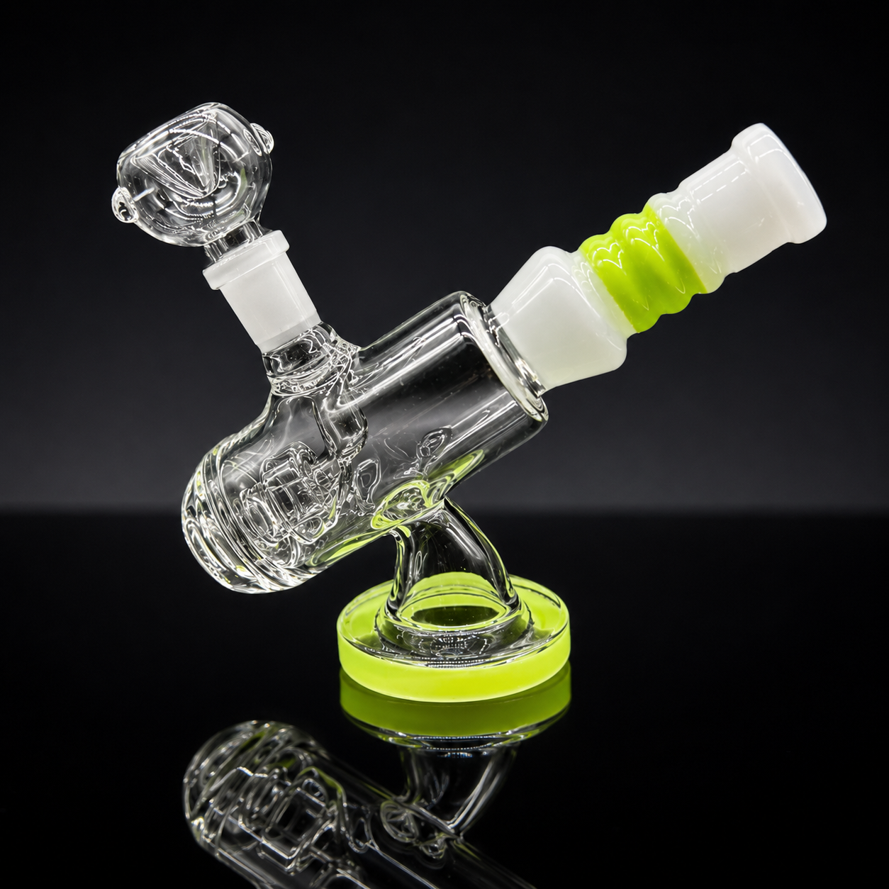 Glass smoking device with green and white accents on a black background