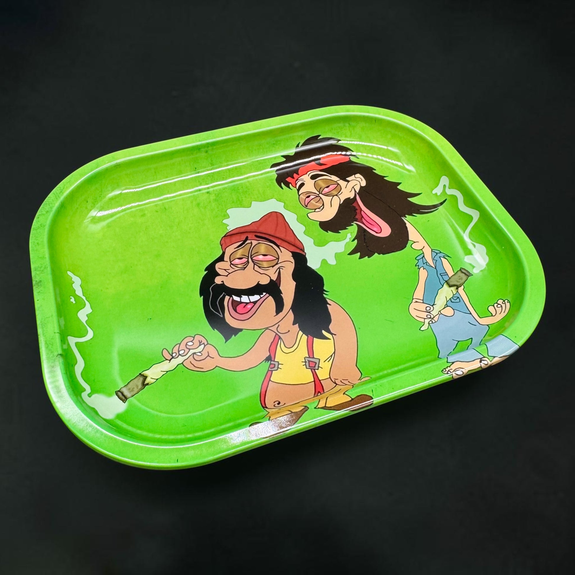 Green tray with cartoon characters smoking on a black background