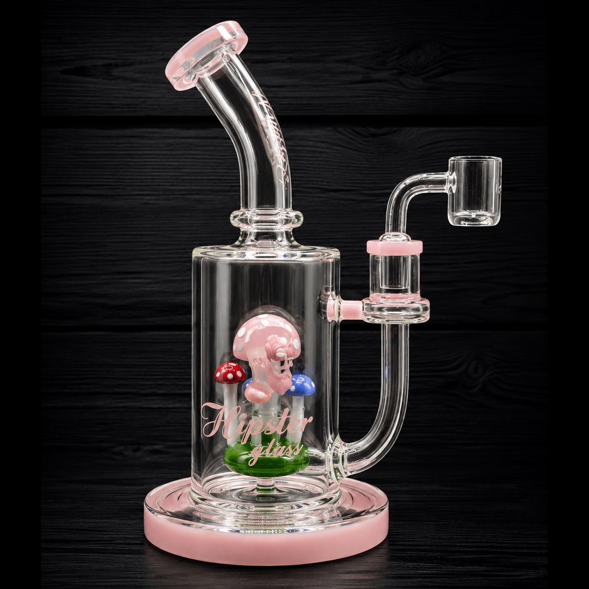 Glass water pipe with pink base and clear chamber on a dark background