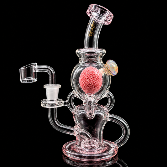 Glass water pipe with pink and clear components on a black background