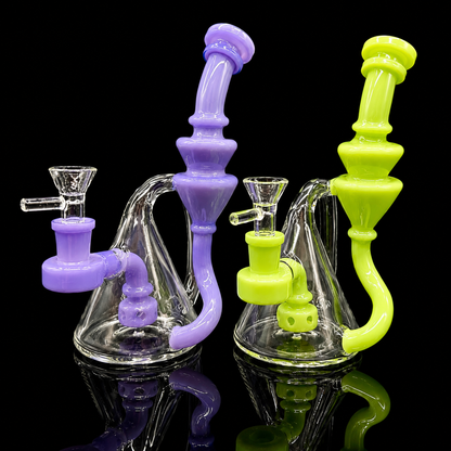 Two glass smoking accessories, one purple and one green, on a black background.
