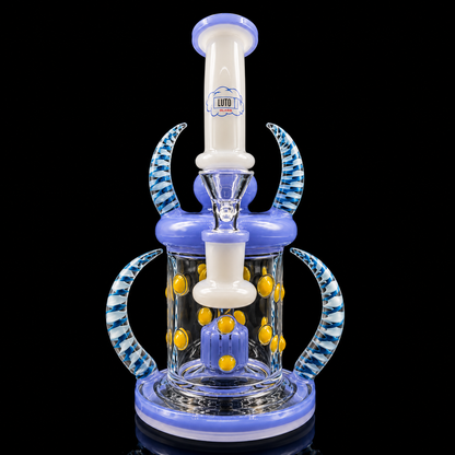 Glass water pipe with blue and white design on a black background