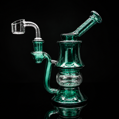 Green glass water pipe on a black background