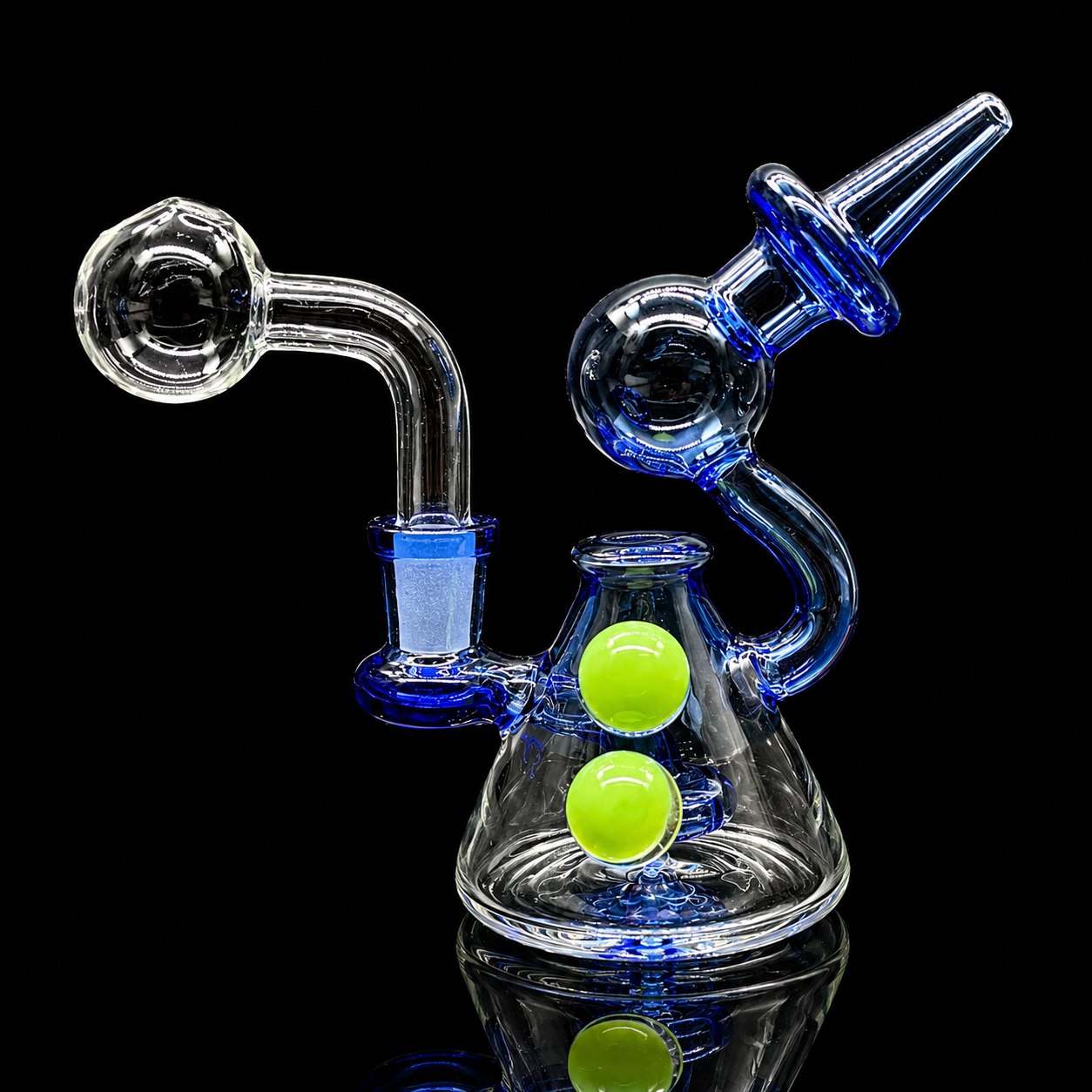 Glass water pipe with blue and green accents on a black background