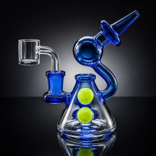 Glass smoking device with blue and clear components on a reflective surface.