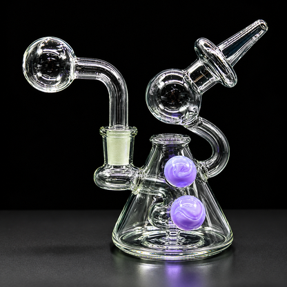 Glass smoking device with purple balls on a black background