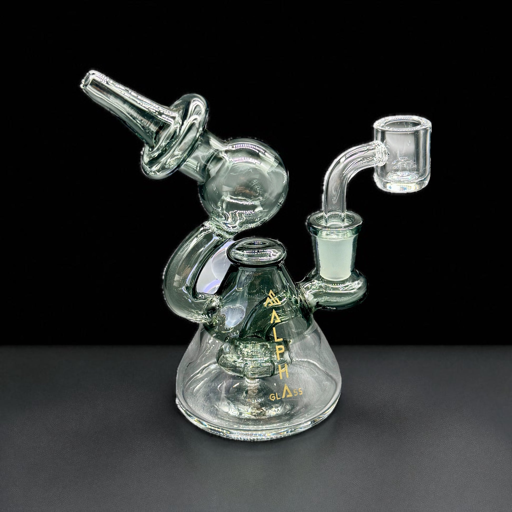 Clear glass smoking device with 'Alpha' branding on a black background
