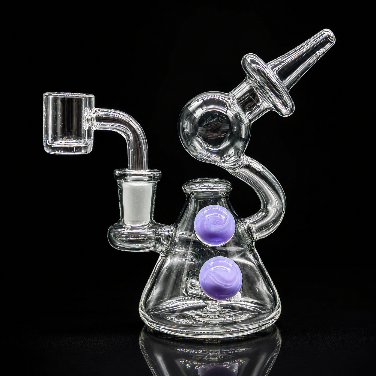 Clear glass water pipe with purple bowls on a black background