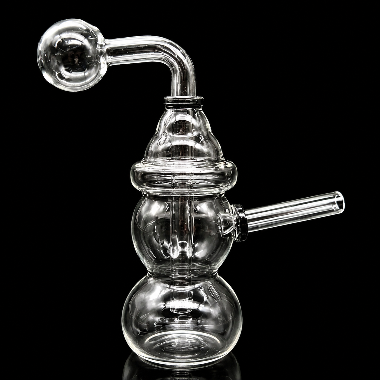 Clear glass smoking device with multiple chambers on a black background