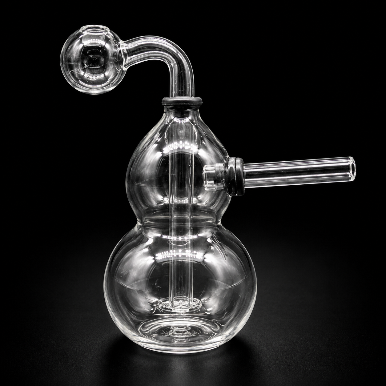 Clear glass smoking device on a black background