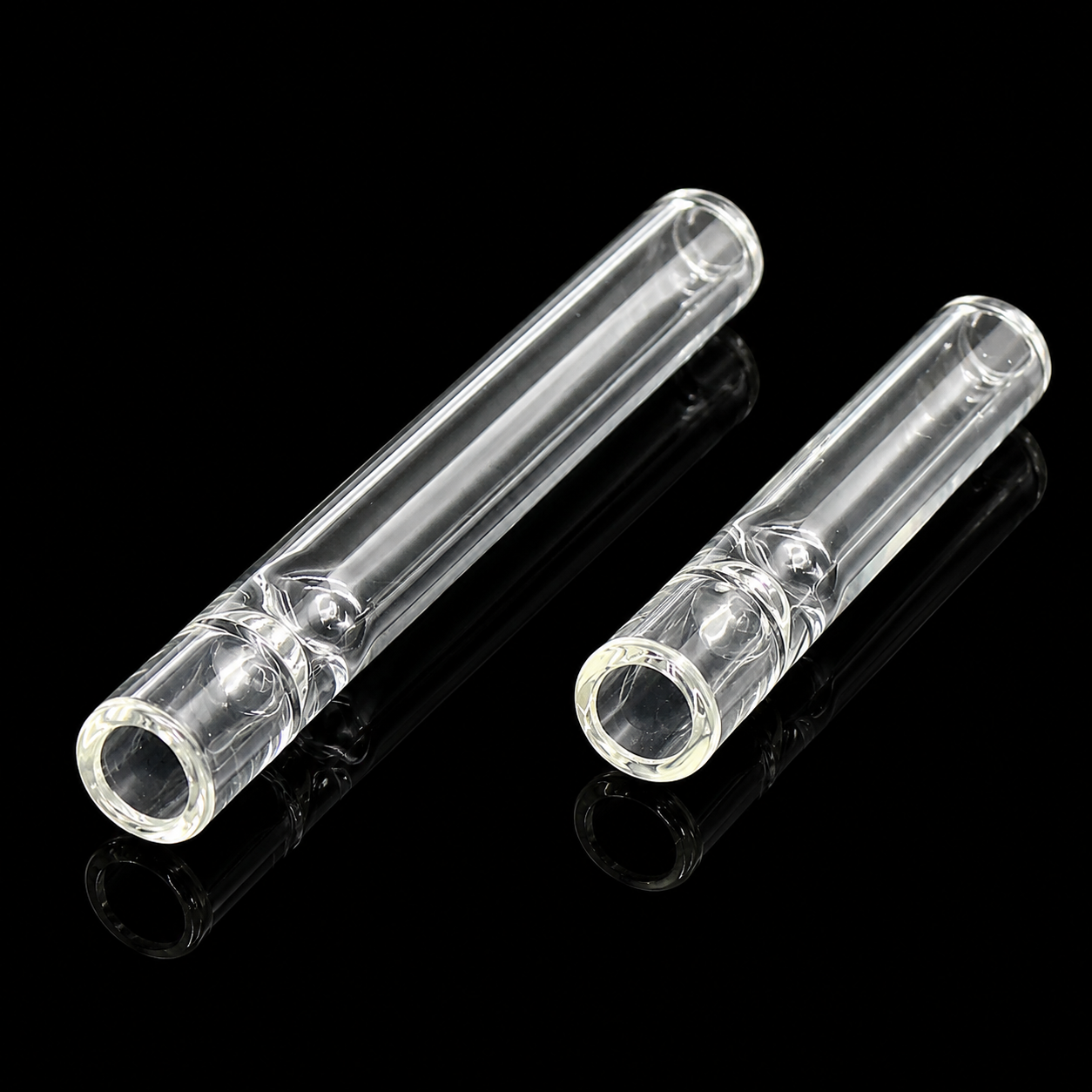 Two clear glass tubes on a black background