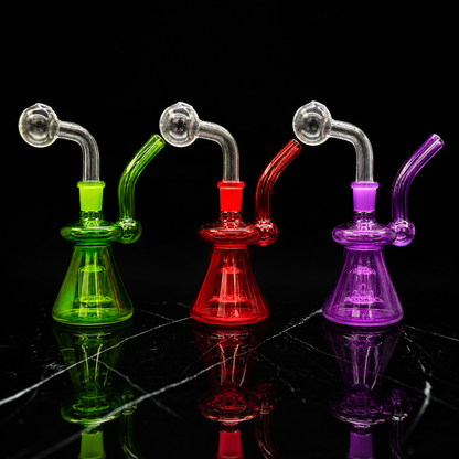 Three colorful glass smoking devices on a reflective black surface with a black background