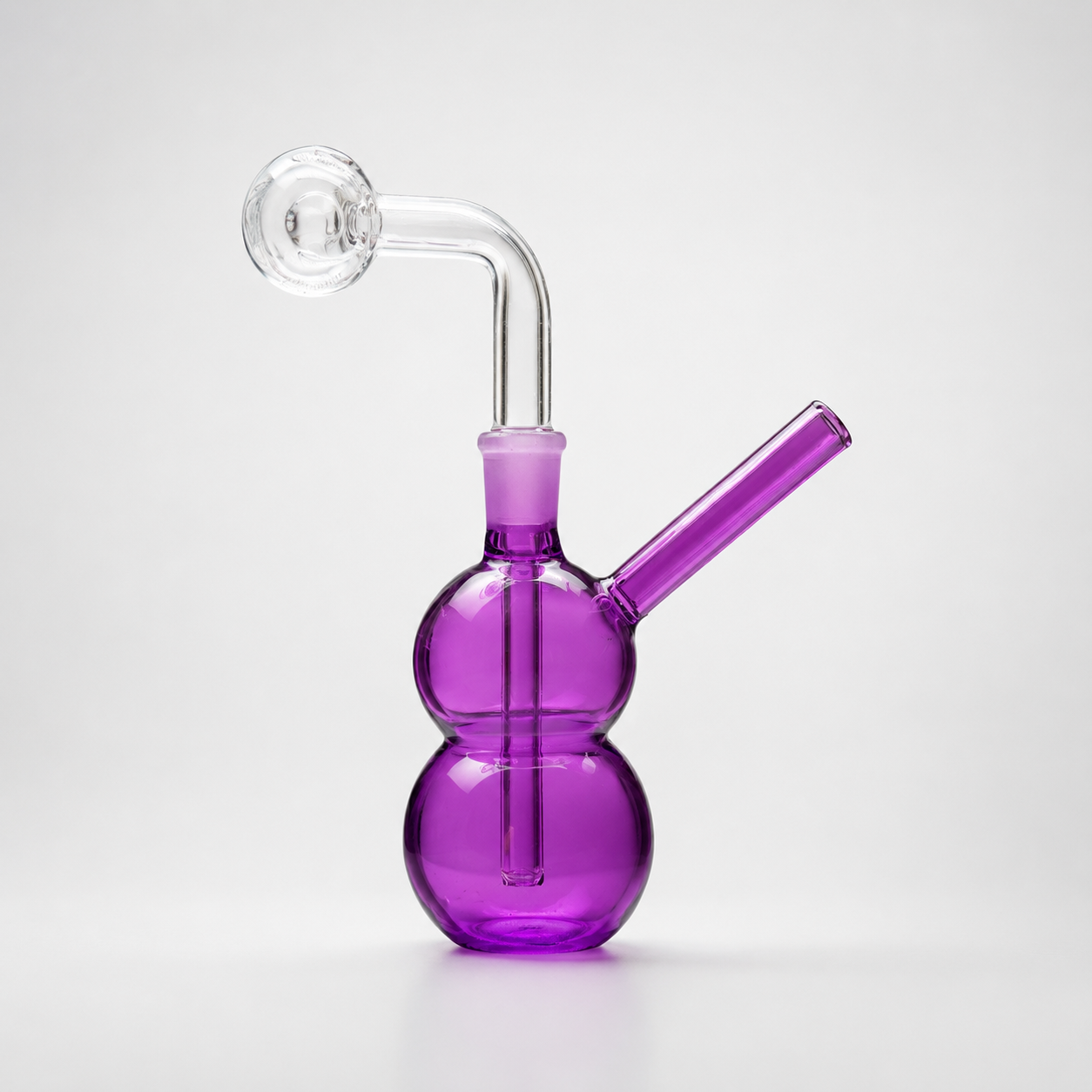 Purple glass smoking device on a white background