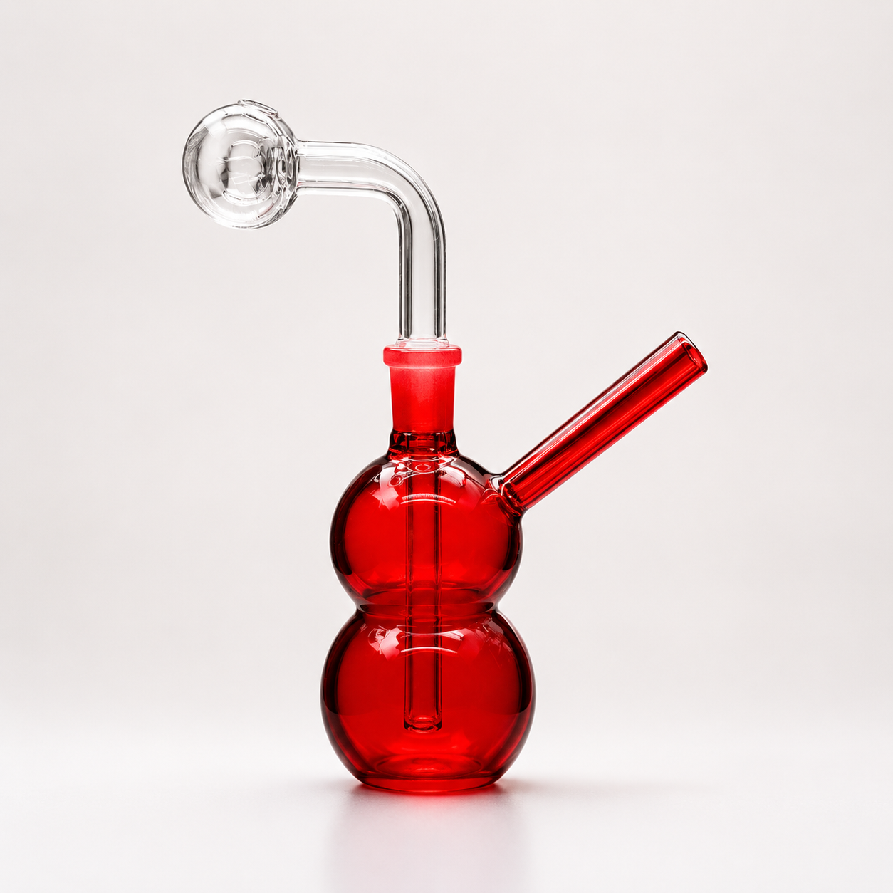 Red glass smoking device with a white background