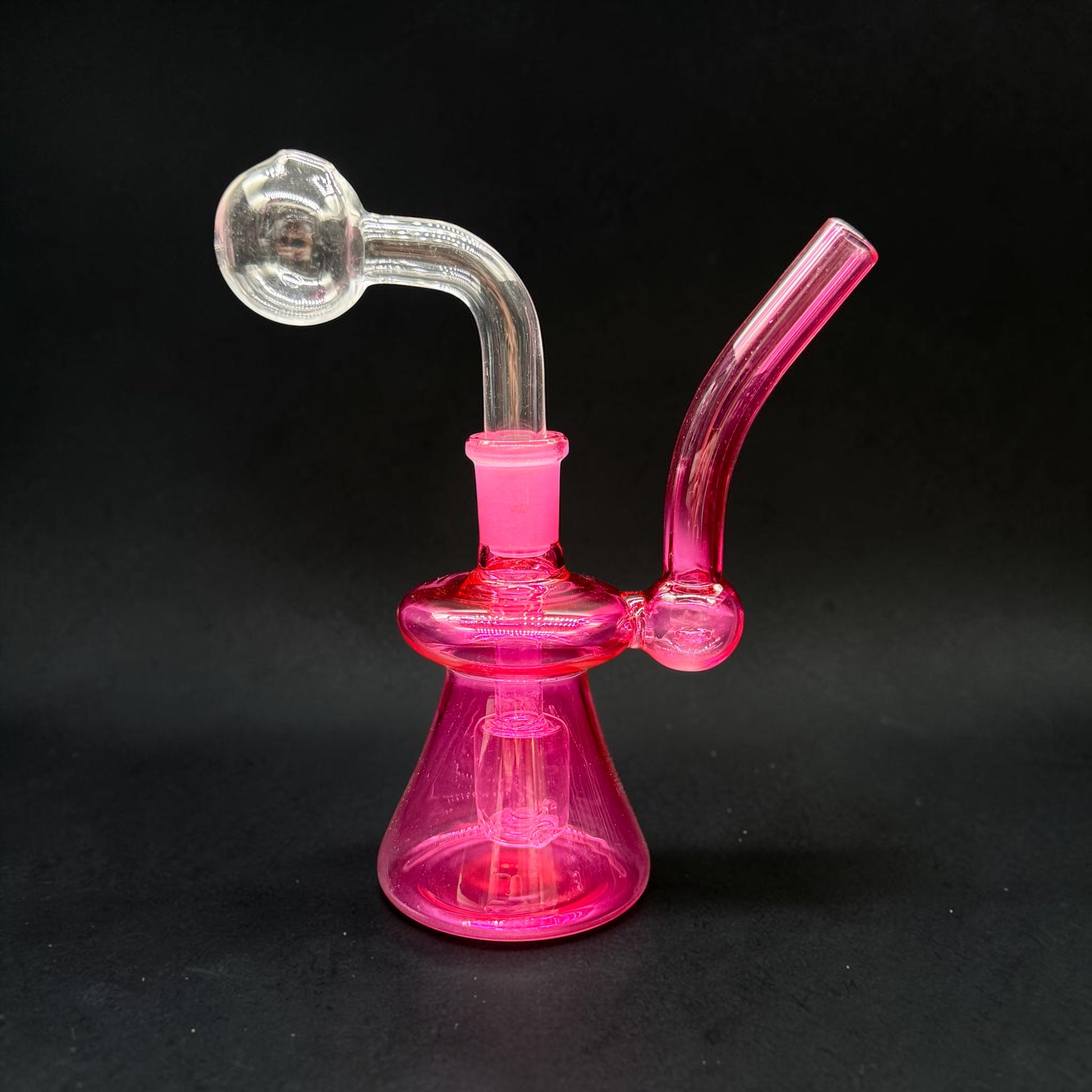 Pink glass water pipe on a black background