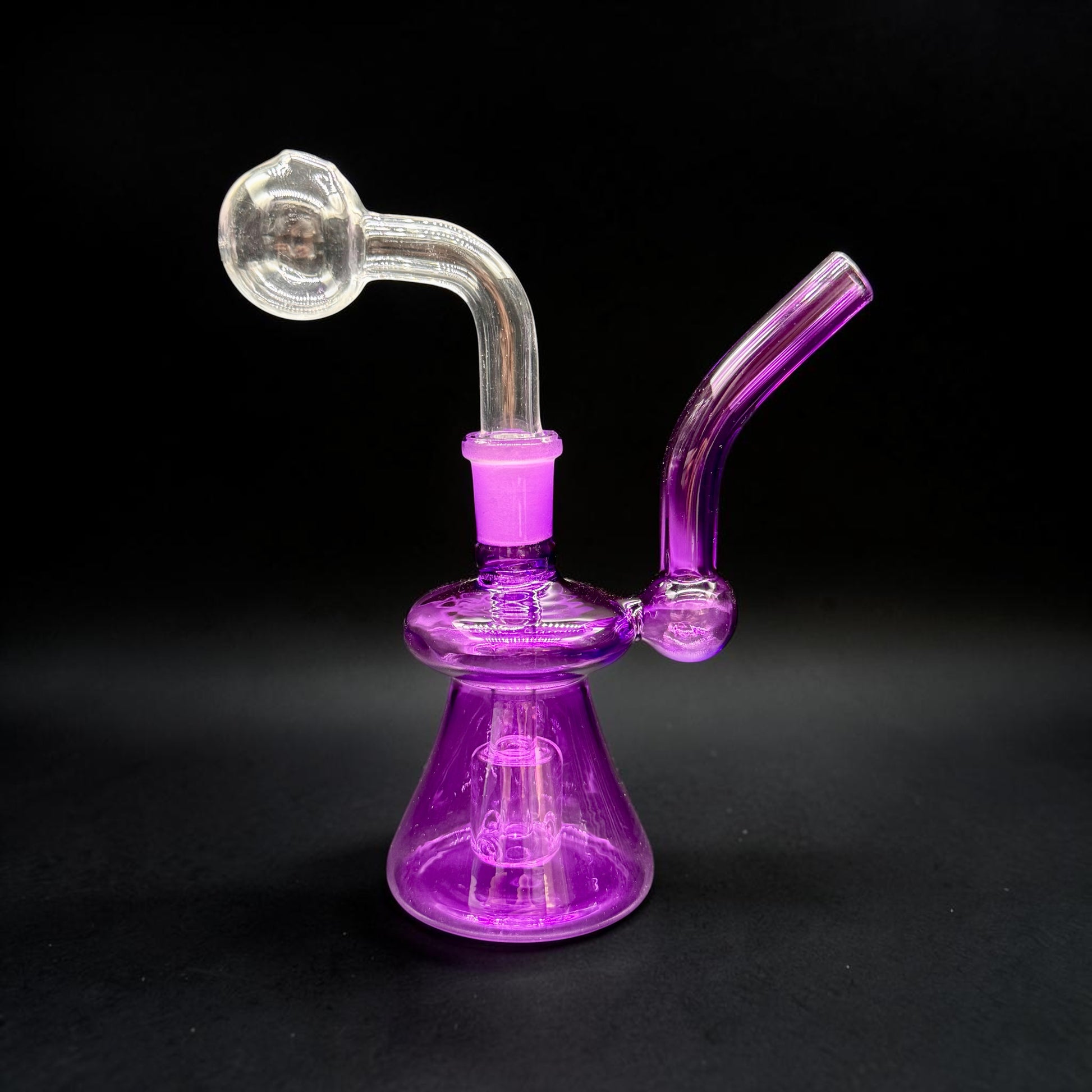 Purple glass smoking device on a black background