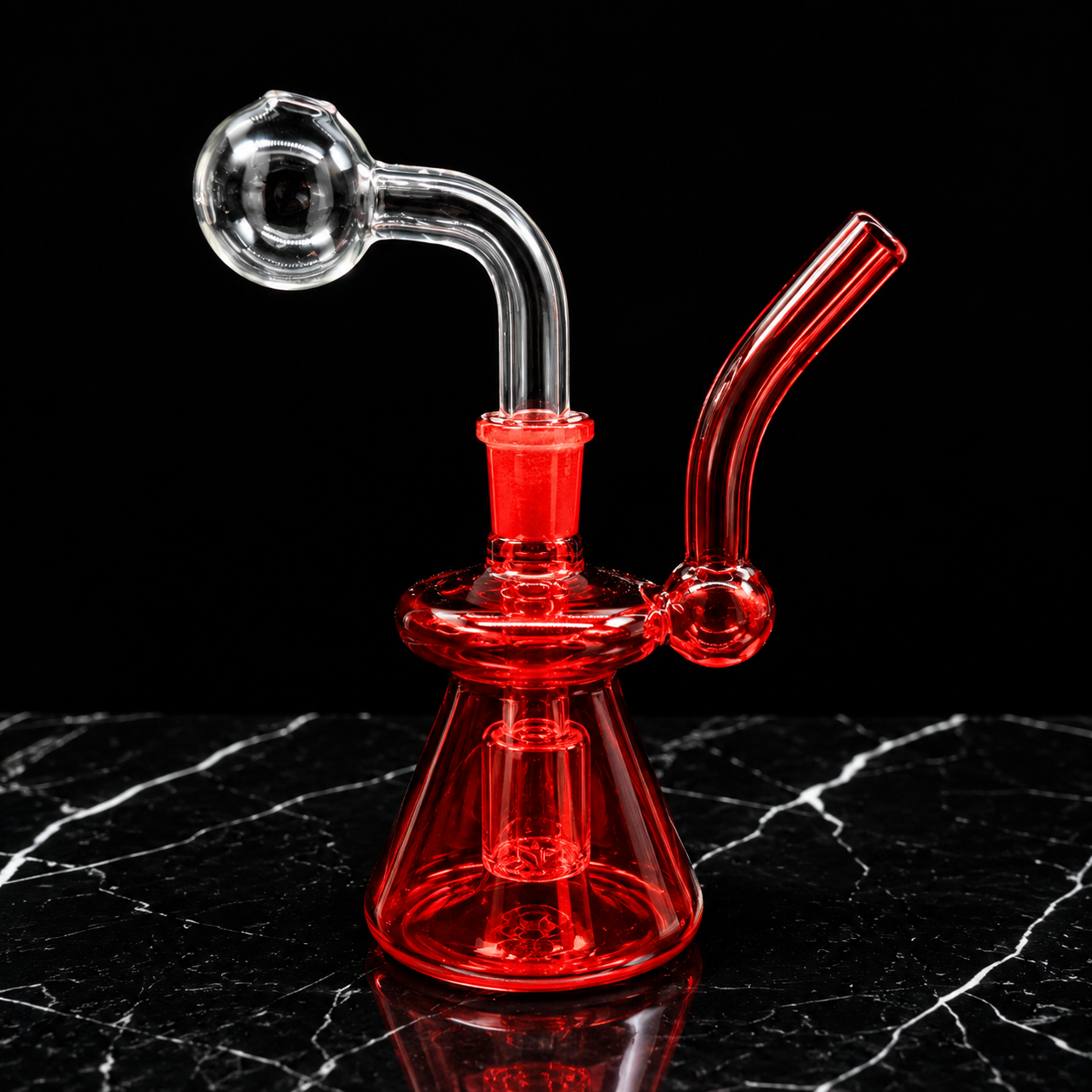 Red glass water pipe on a black marble surface with a black background