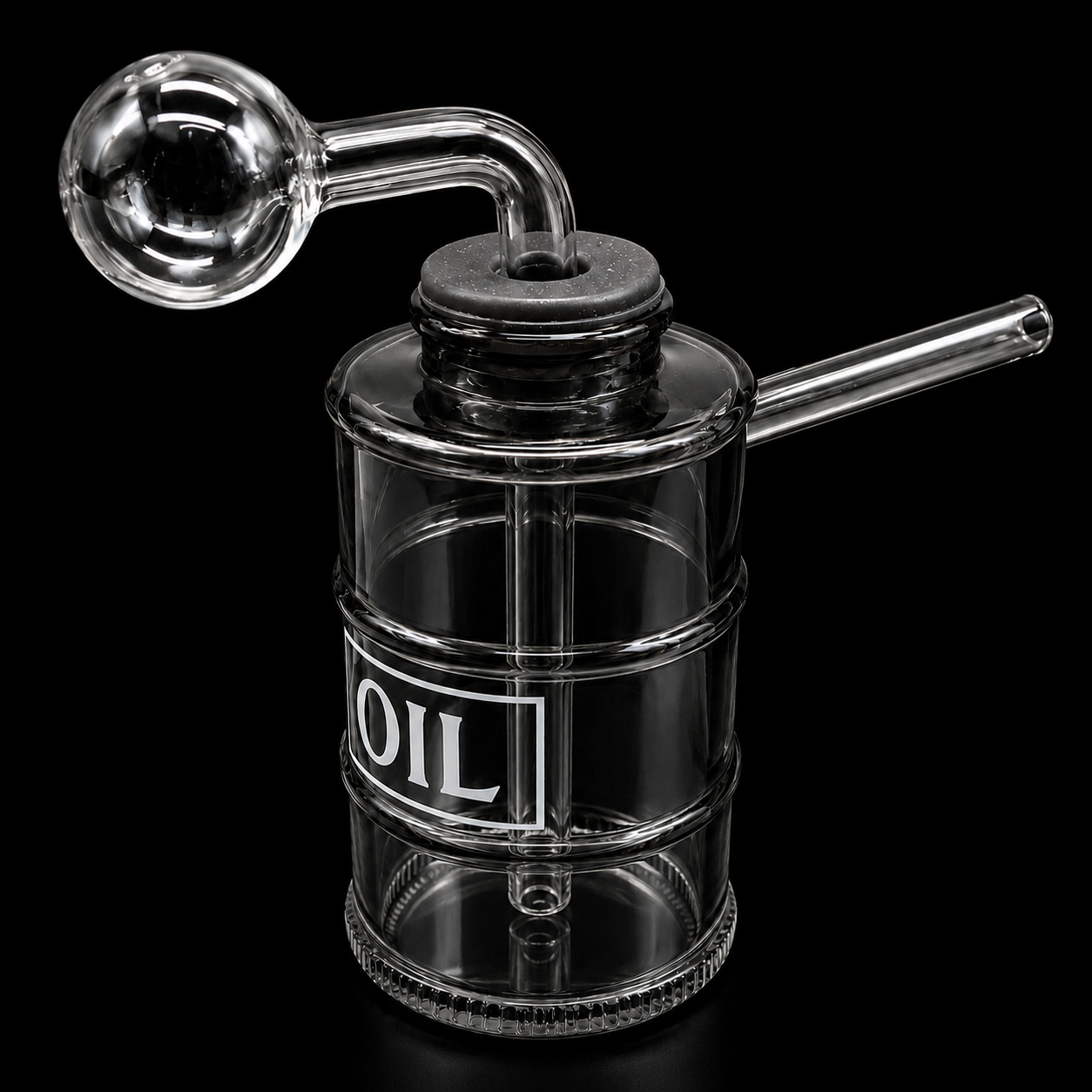 Clear glass oil container with a label on a black background