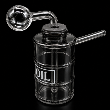 Clear glass oil container with a label on a black background