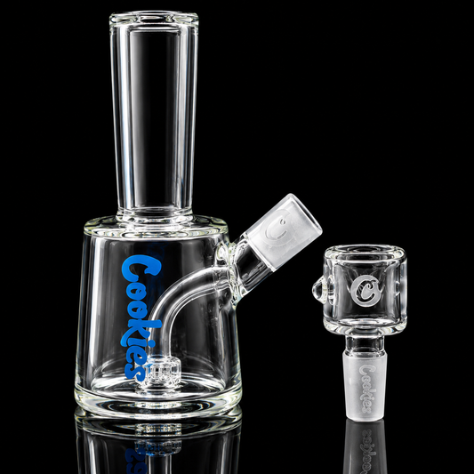 Clear glass smoking apparatus with 'Cookies' branding on a black background