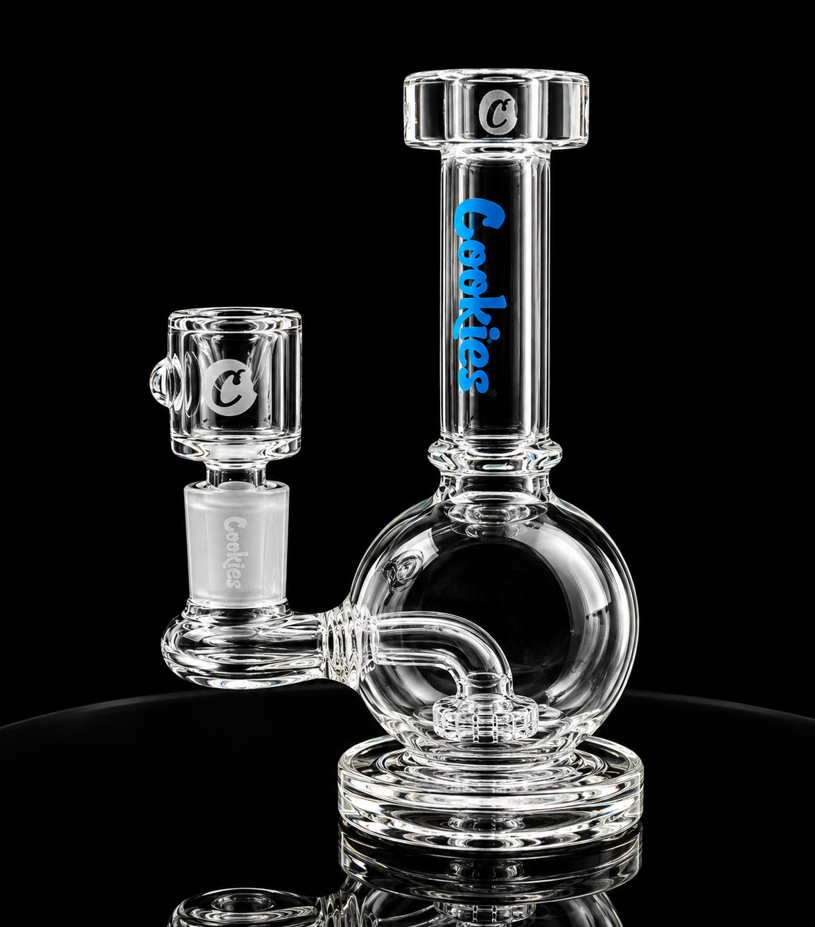 Clear glass smoking device with 'Cookies' branding on a black background