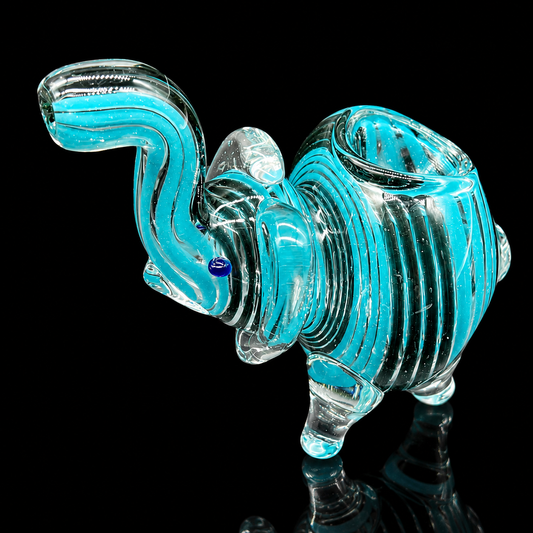 Glass elephant figurine with a blue tint on a black background