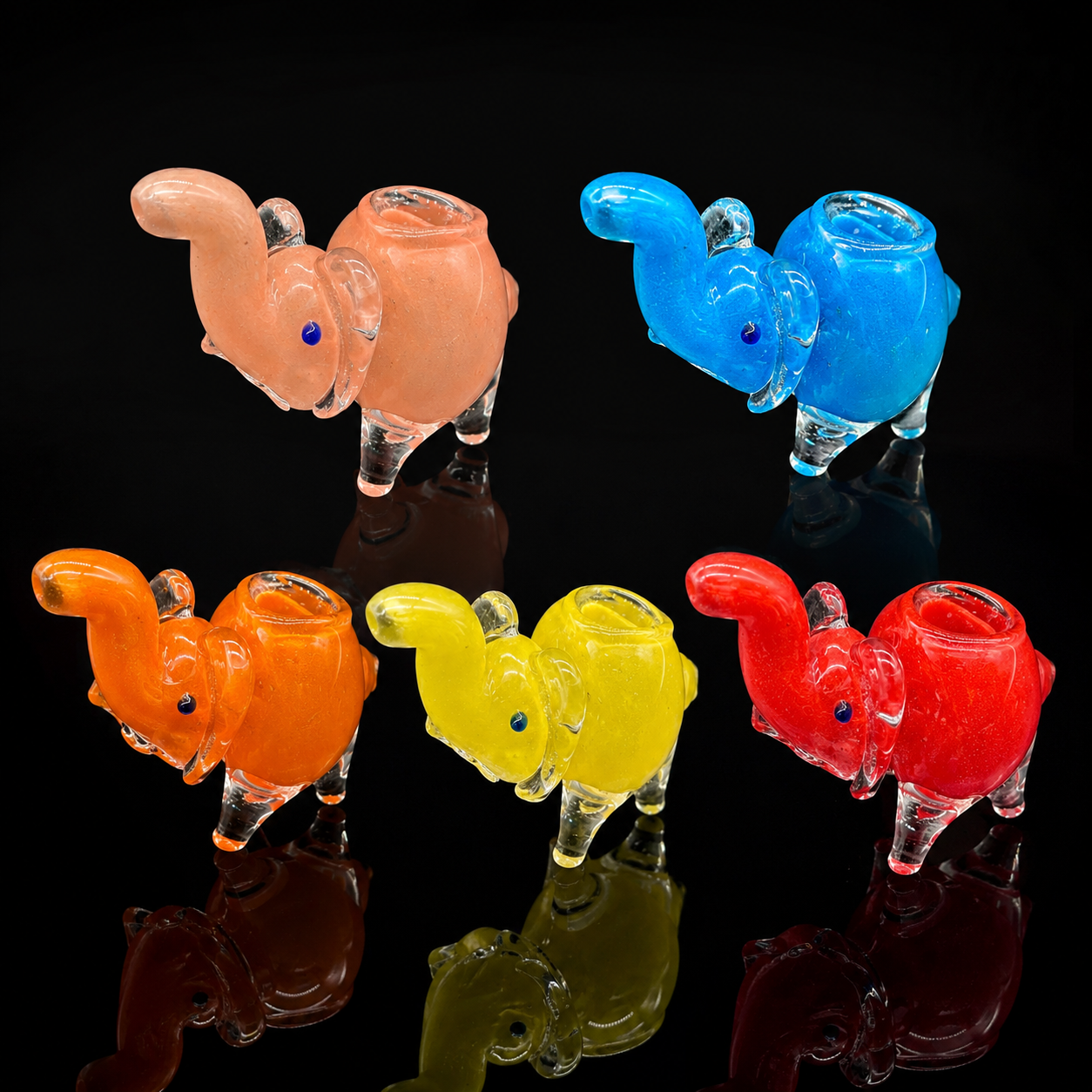 Set of colorful glass elephant-shaped pipes on a black background