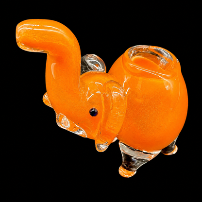 Glass elephant figure in orange on a black background