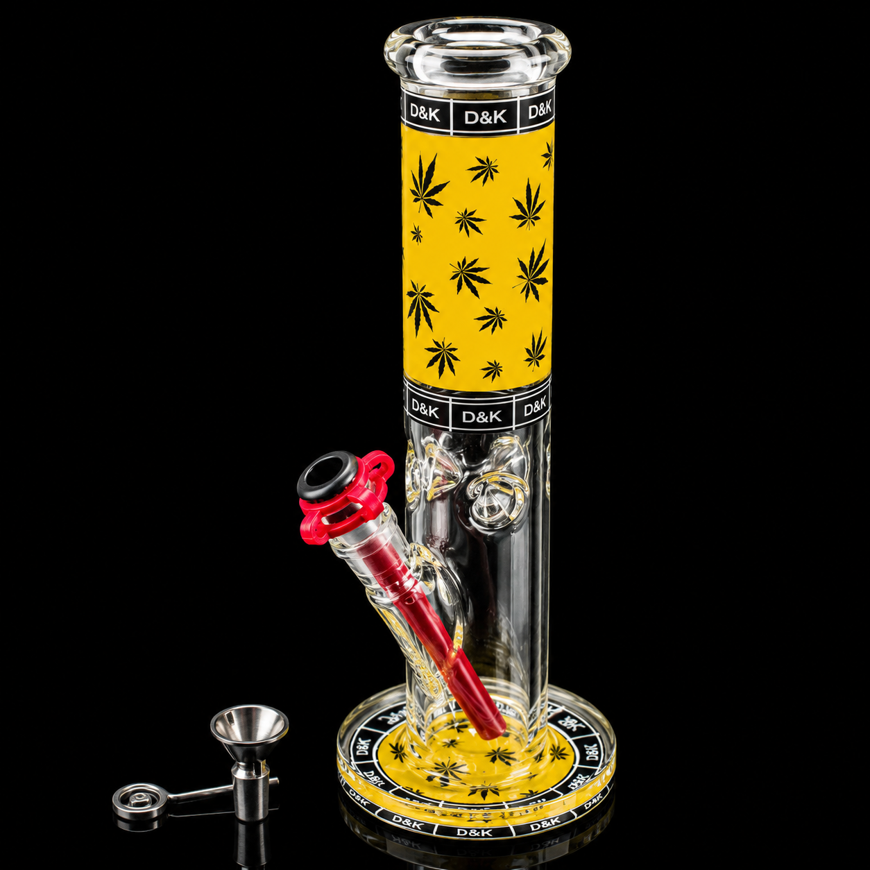Glass smoking device with yellow top and black leaf patterns on a black background