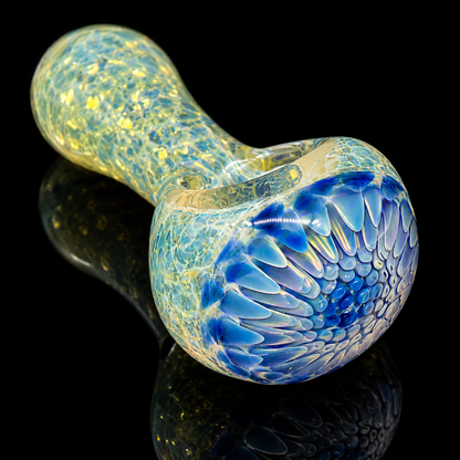 Glass smoking pipe with blue and yellow pattern on a black background