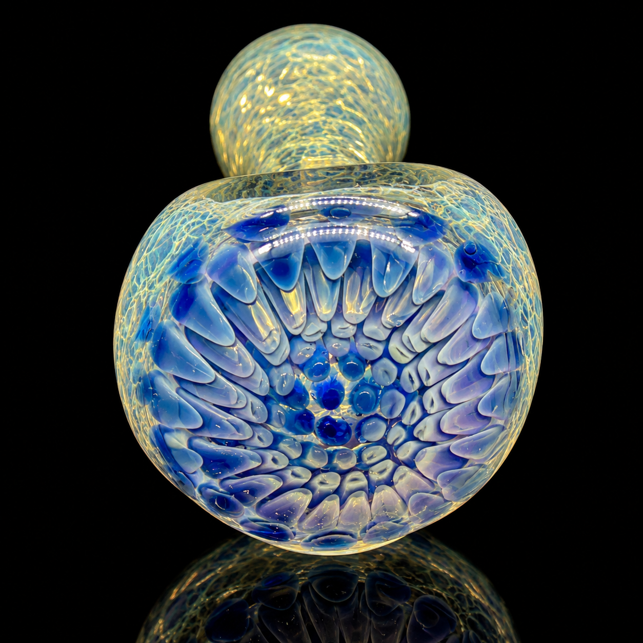Glass pipe with blue and yellow pattern on a black background