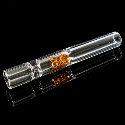 Clear glass smoking device with orange center on a black background