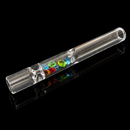 Clear glass pipe with colorful gemstones on a black background