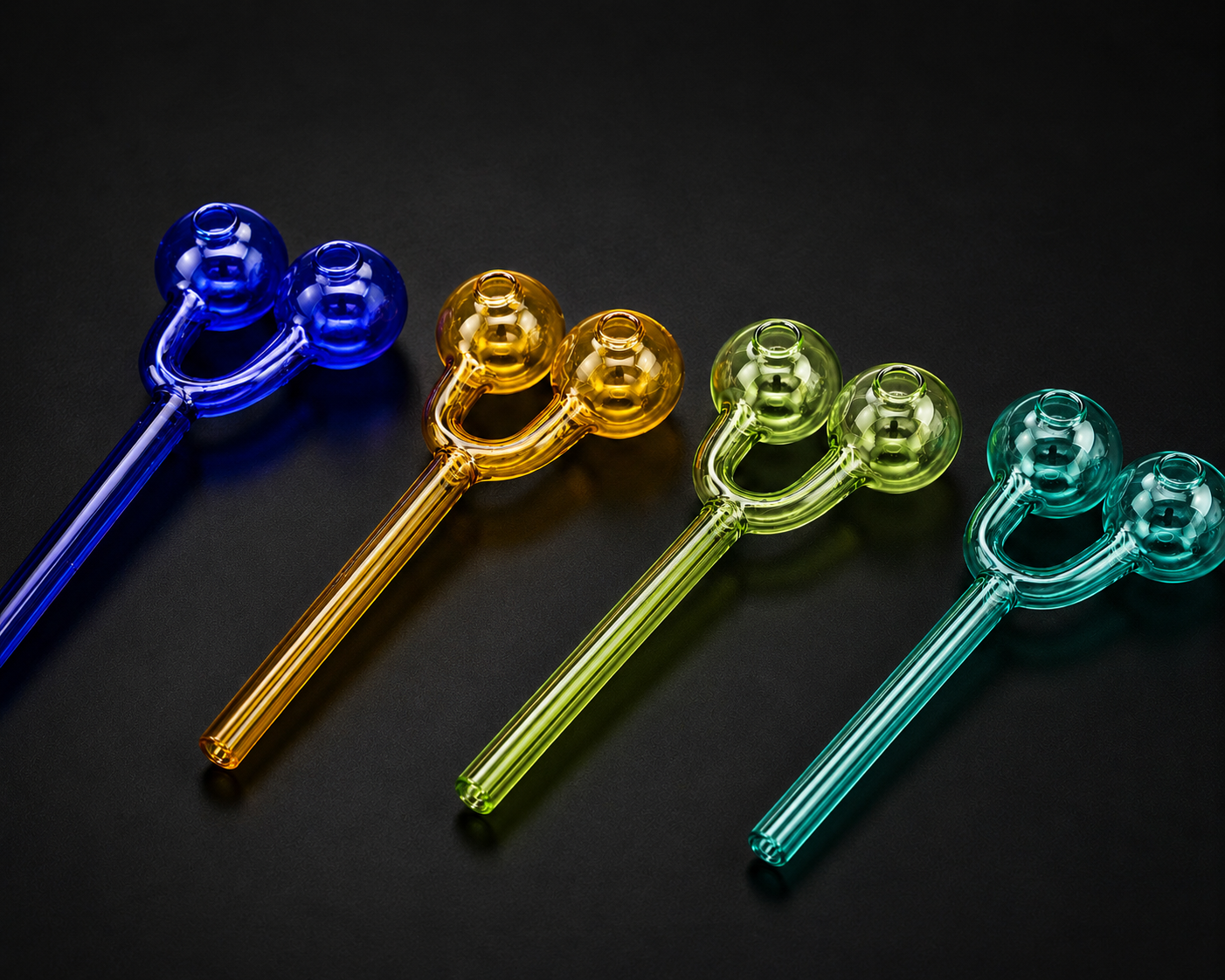 Set of colorful glass stir sticks on a black background