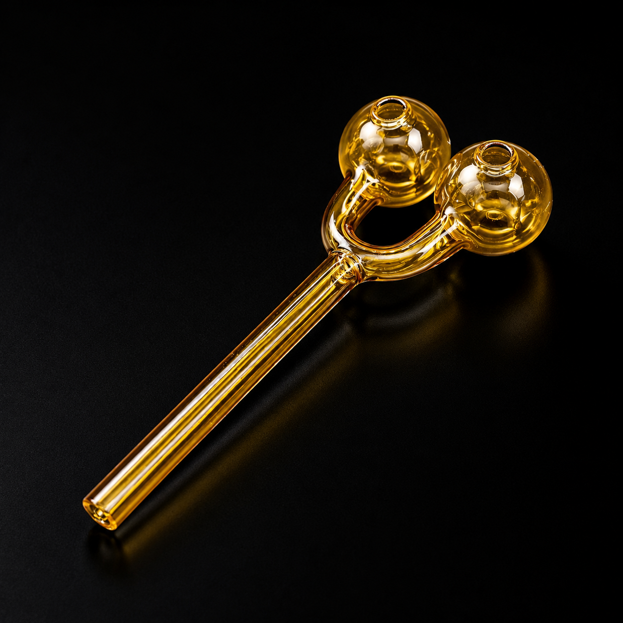 Glass smoking device with two bowls on a black background