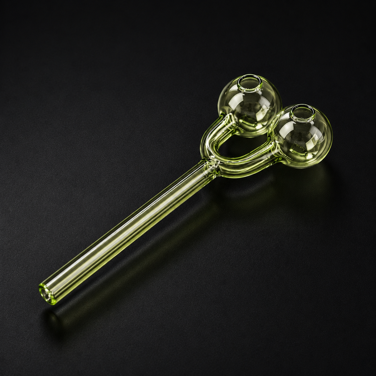 Glass smoking pipe with two chambers on a black background