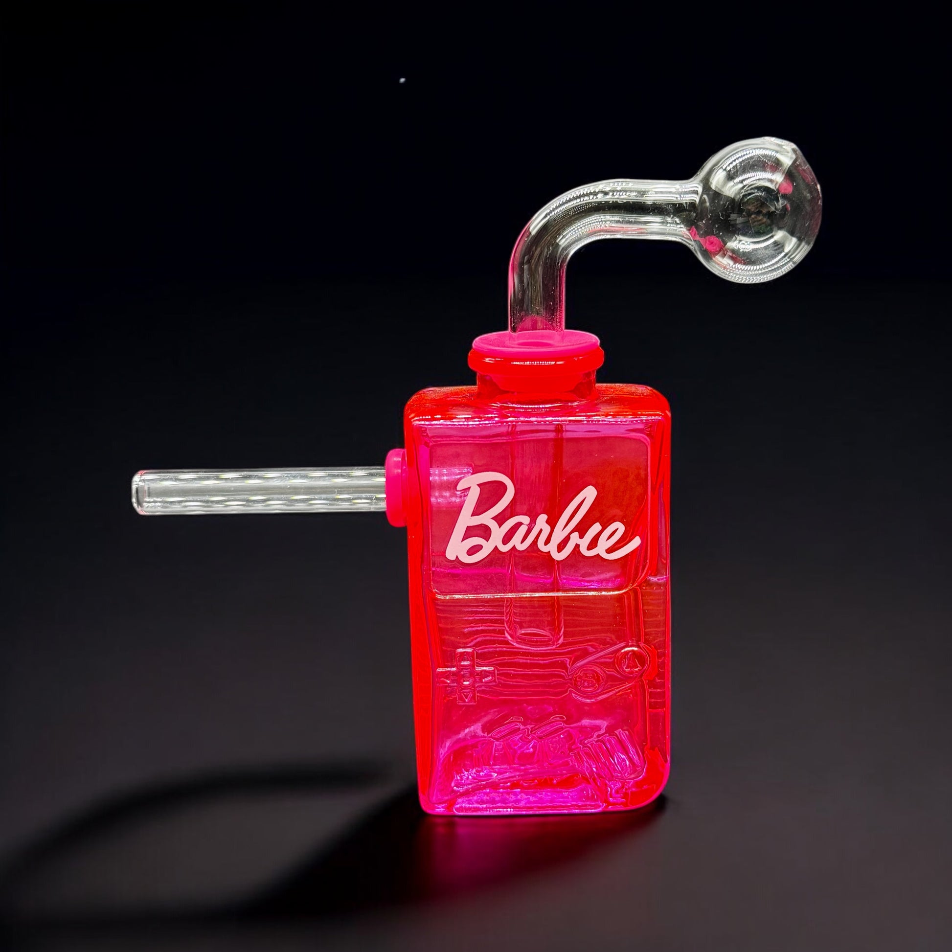 Hot pink Gameboy-style glass bubbler with Barbie-themed label and removable parts