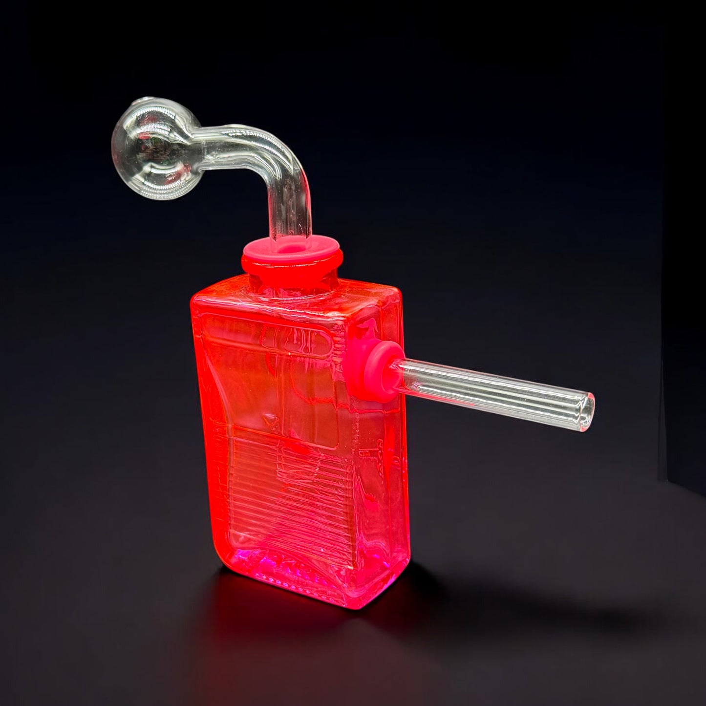 Side-by-side view of hot pink and neon green glass oil burner bubblers with game-inspired designs