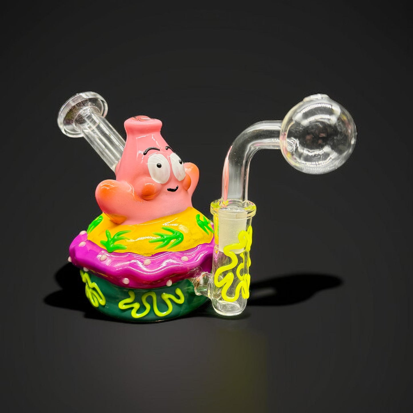 Glass smoking accessory shaped like a cartoon character on a black background