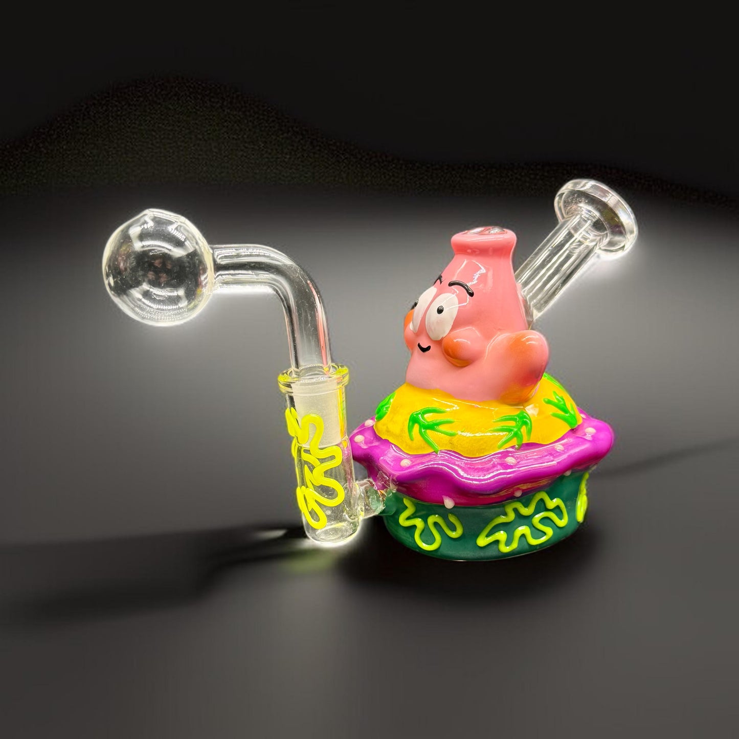 Glass smoking device with cartoon character on a dark background