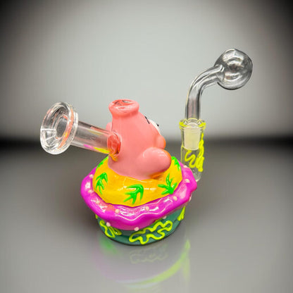 Colorful glass smoking device with a pig design on a gray background