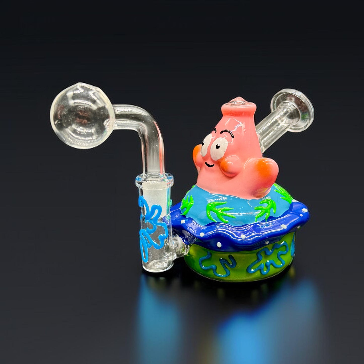 Glass smoking device shaped like a cartoon character on a black background