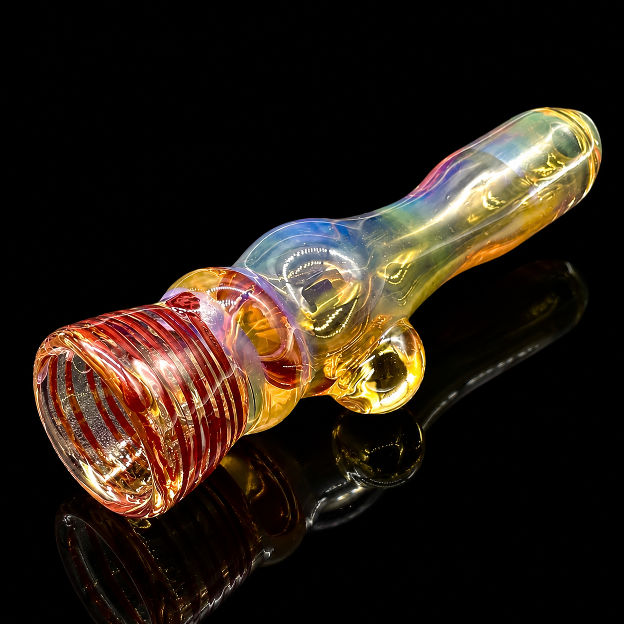 Glass smoking pipe with multicolored swirl design on a black background