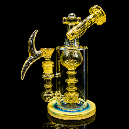 Glass smoking device with yellow and clear components on a black background