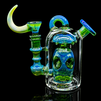Glass smoking device with blue and green colors on a black background