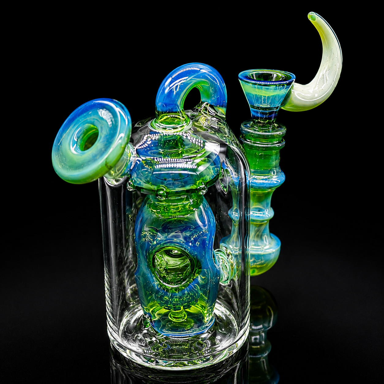 Colorful glass smoking device with blue and green accents on a black background