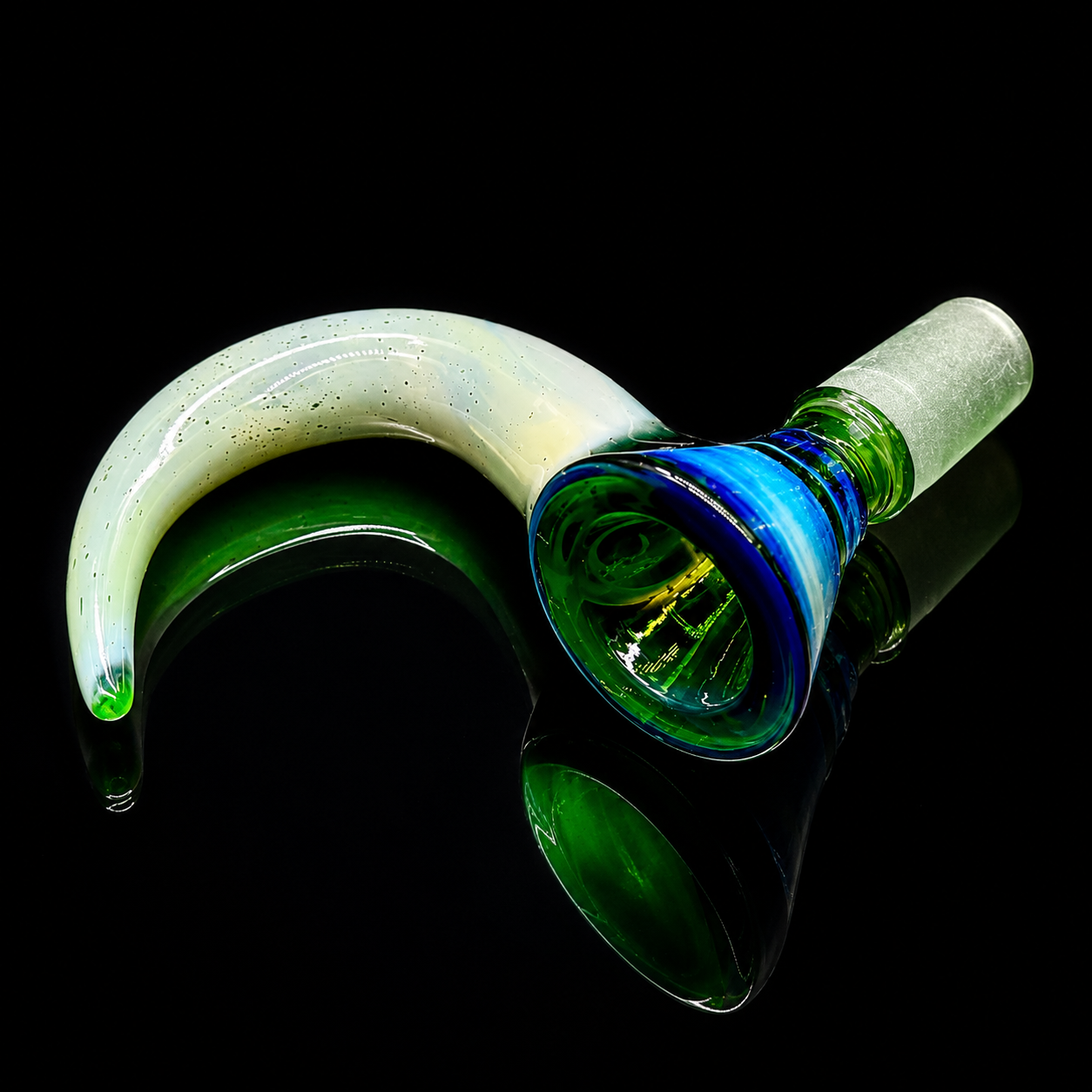 Glass smoking pipe with green and blue swirl design on a black background
