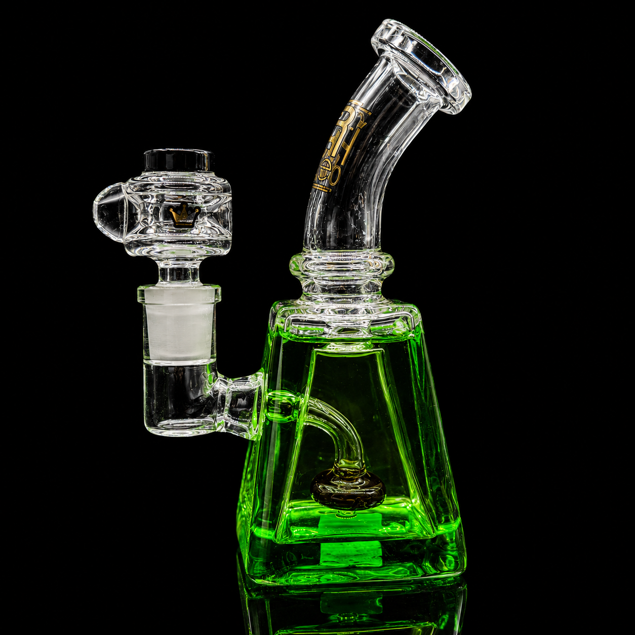Glass water pipe with green base on a black background