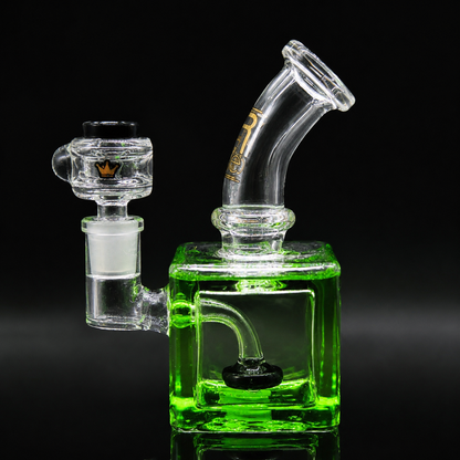 Glass smoking device with green base on a black background