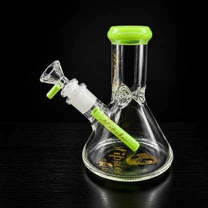 Glass beaker water pipe with green accents on a black background